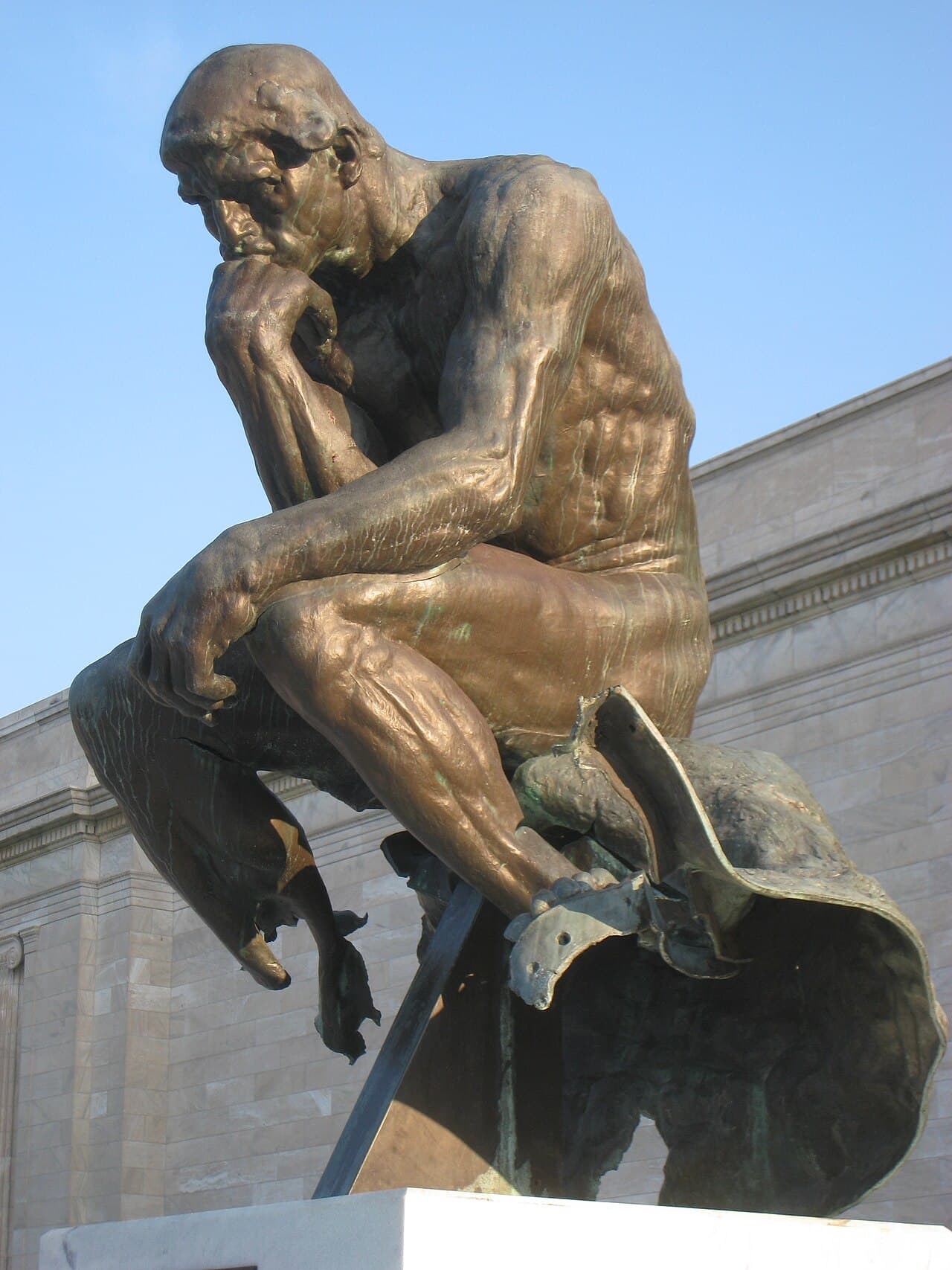 Bronze cast of Auguste Rodin's The Thinker on the front steps of the Cleveland Museum of Art, showing damage from a 1970 bombing