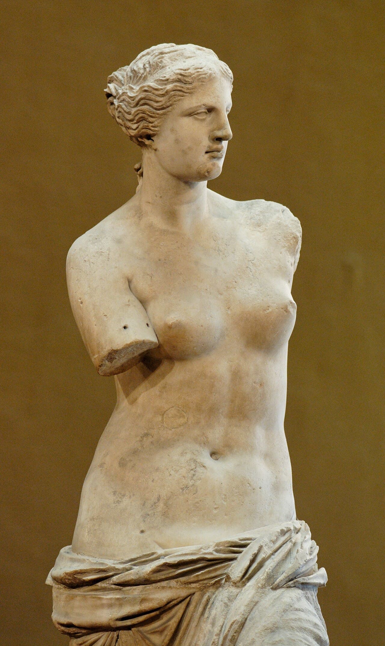 The Venus de Milo, an armless marble statue of a woman in draped clothing