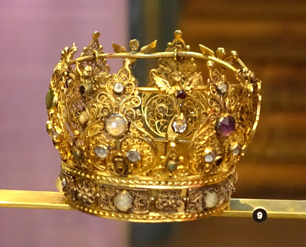 Embroidered Swedish folk costume and silver bridal crown on display