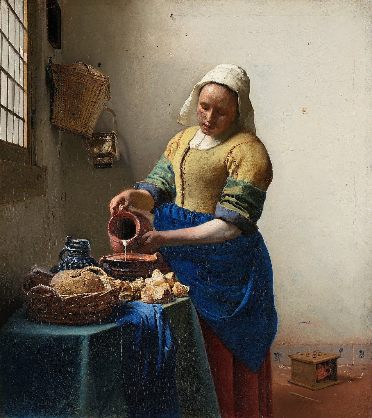 Vermeer's The Milkmaid, showing a maid pouring milk in a sunlit kitchen