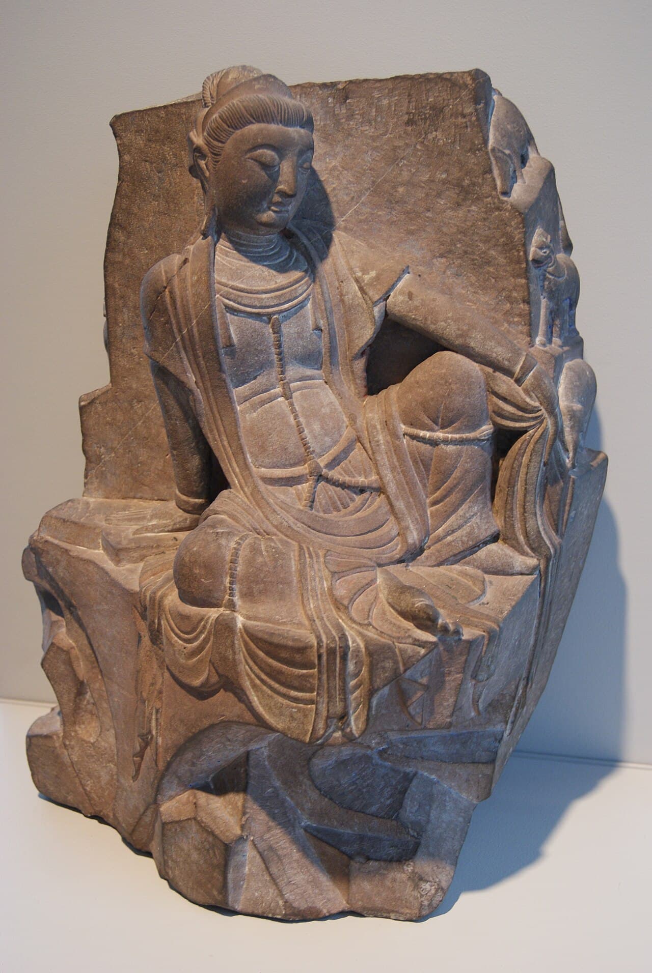 Seated Bodhisattva figure in relaxed royal-ease posture